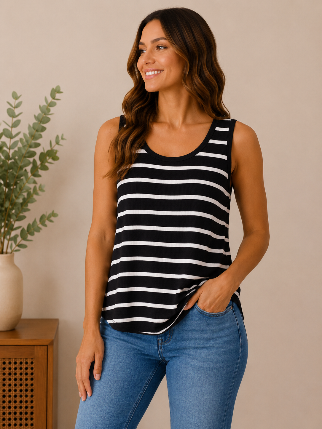 Woman wearing the everyday essential striped tank in black / white stripe.