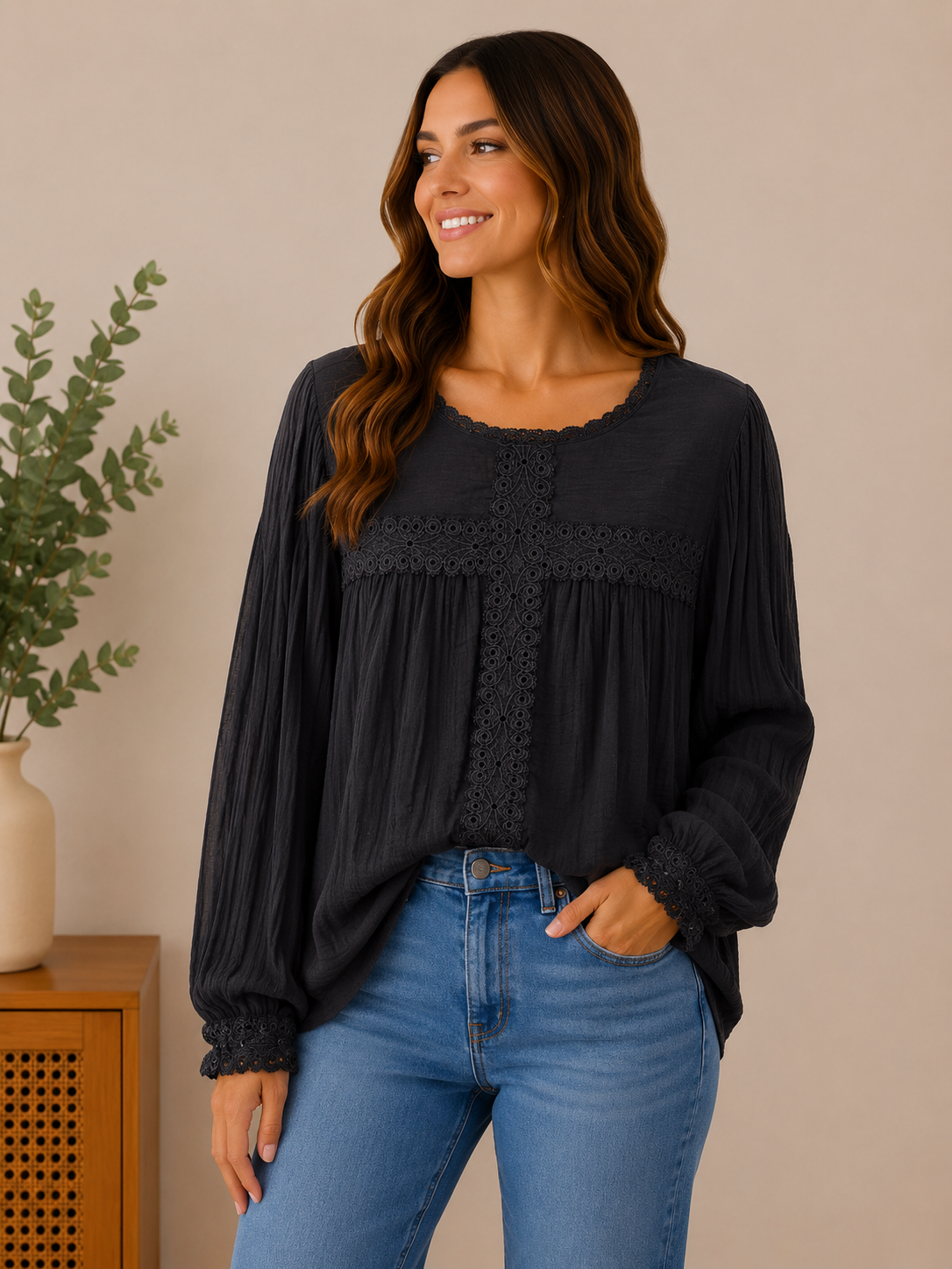 Woman wearing the midnight romance lace-trim blouse in black / charcoal.