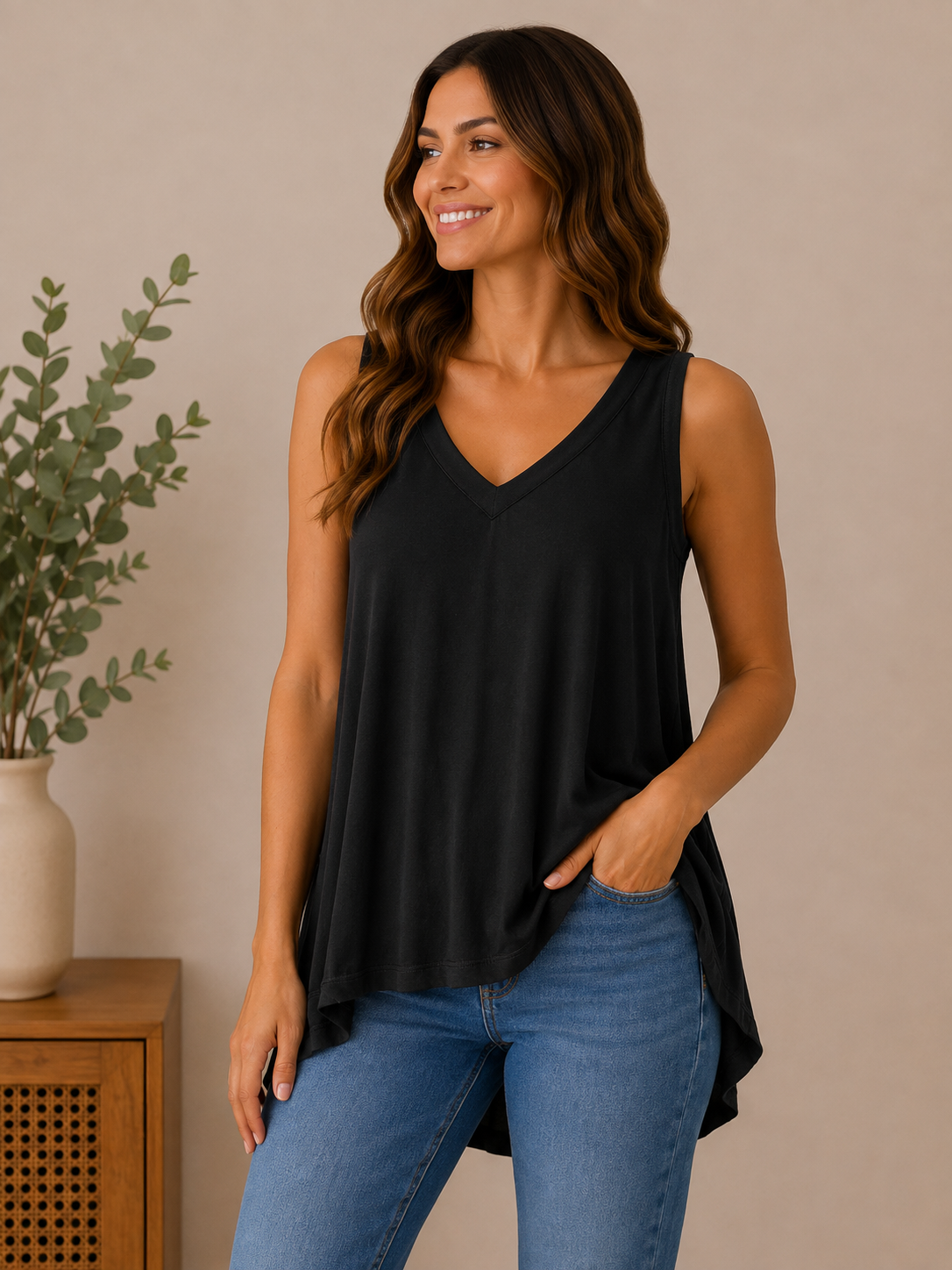 Woman wearing the effortless flow v-neck tank in black.