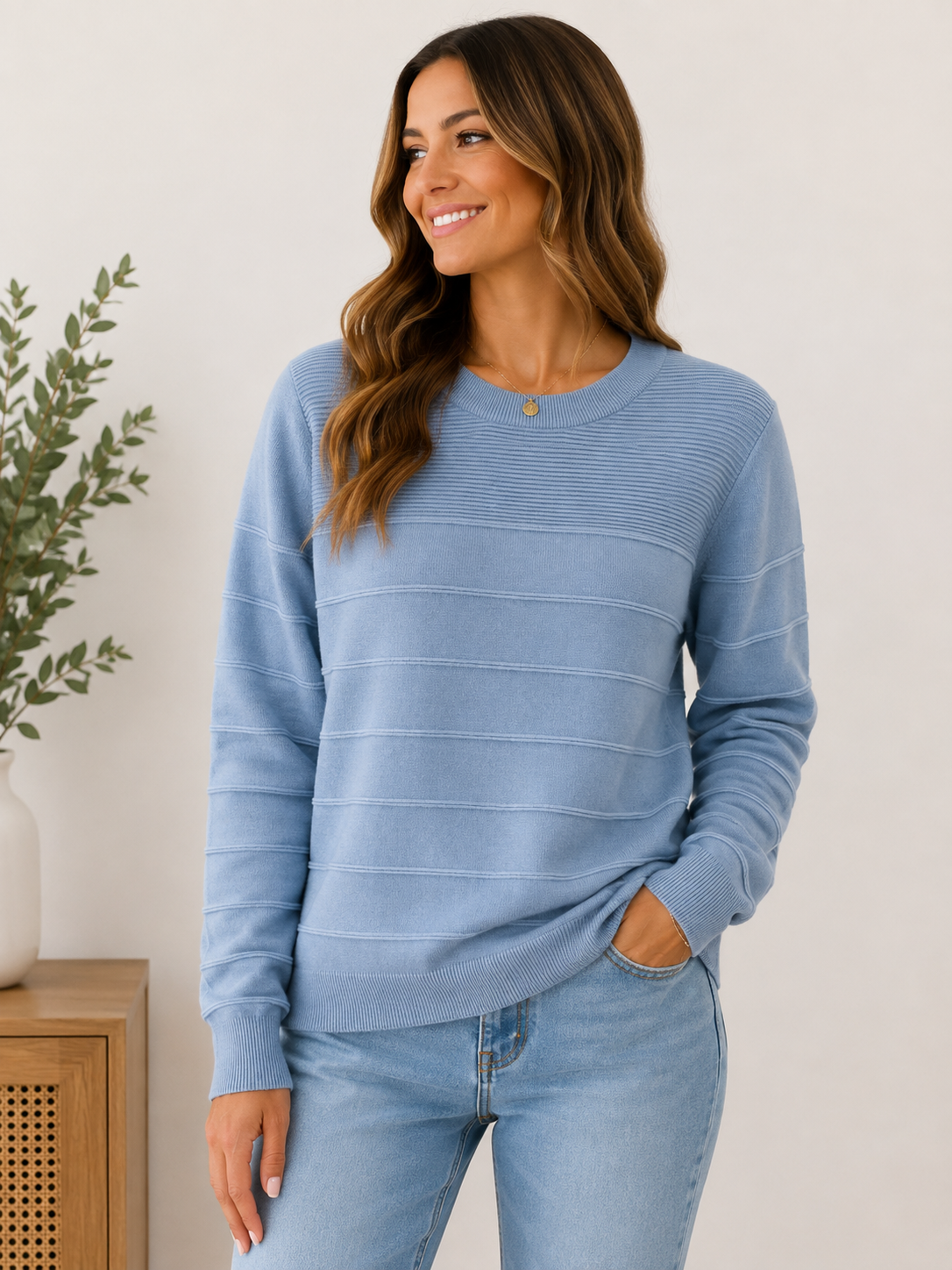 Woman wearing the blue skies textured knit sweater in powder blue.